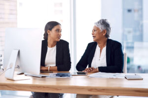 Two racialized women talking to each other.